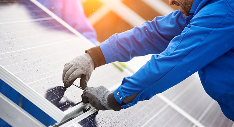 engineer installing a solar panel